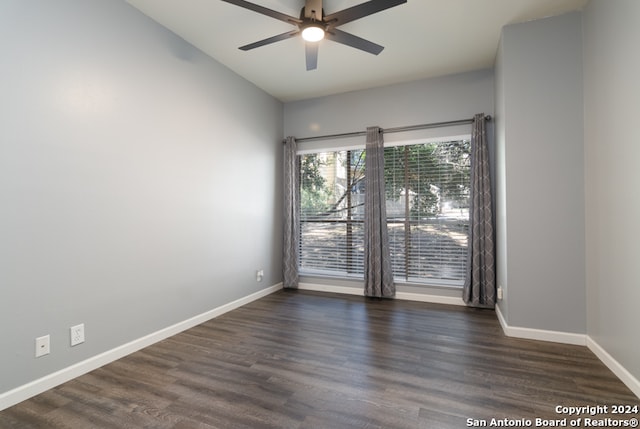 unfurnished room with ceiling fan and dark hardwood / wood-style flooring