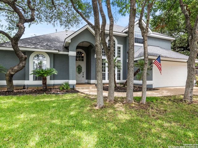 ranch-style house featuring a garage and a front yard