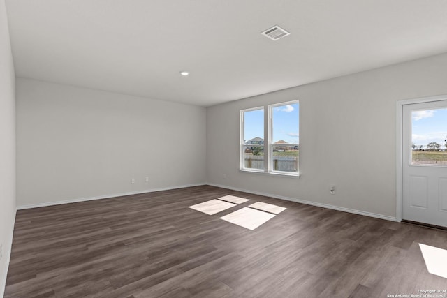 spare room with dark hardwood / wood-style flooring