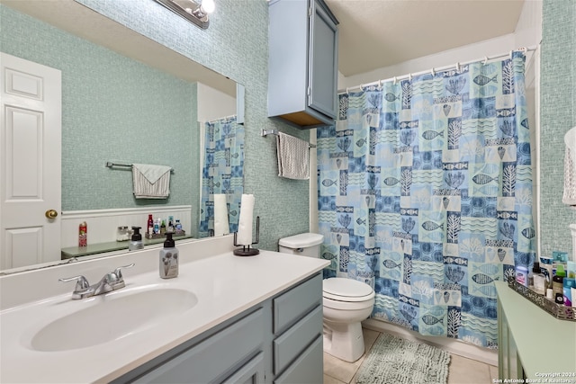 bathroom with tile patterned floors, vanity, and toilet