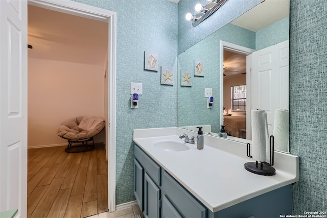 bathroom featuring ceiling fan, vanity, and wood-type flooring