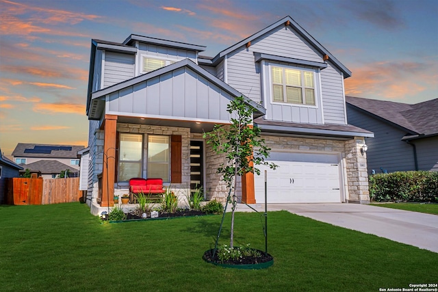 craftsman inspired home with a lawn, a garage, and covered porch