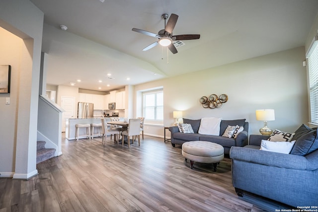 living room featuring light wood-type flooring, ceiling fan, and lofted ceiling