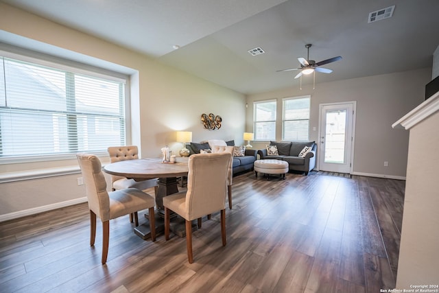 dining area with ceiling fan and dark wood-type flooring