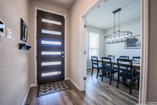 dining area featuring dark hardwood / wood-style floors and a notable chandelier