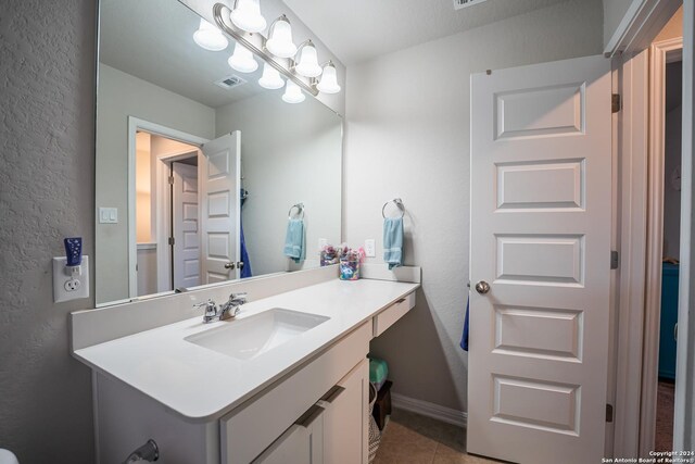 bathroom with tile patterned floors and vanity