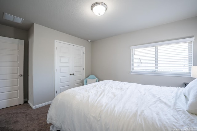 carpeted bedroom with a closet