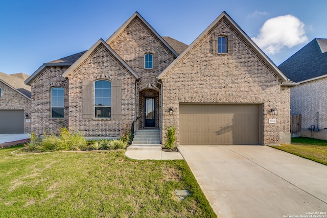 view of front of house with a front yard and a garage