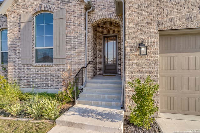 doorway to property with a garage