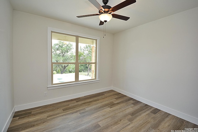 unfurnished room featuring hardwood / wood-style floors and ceiling fan