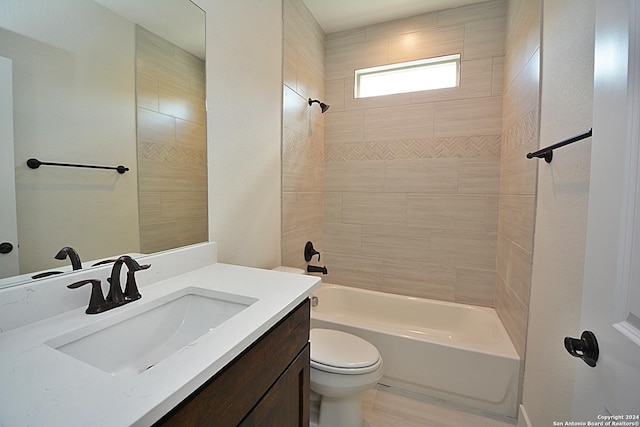 full bathroom with tiled shower / bath combo, vanity, and toilet