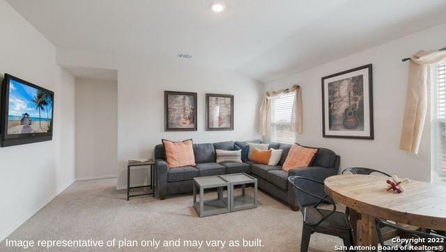 carpeted living room with lofted ceiling