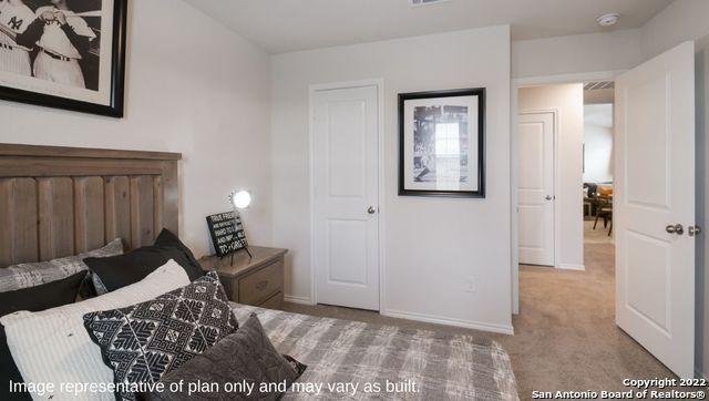 bedroom with light colored carpet