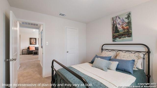 bedroom featuring light carpet