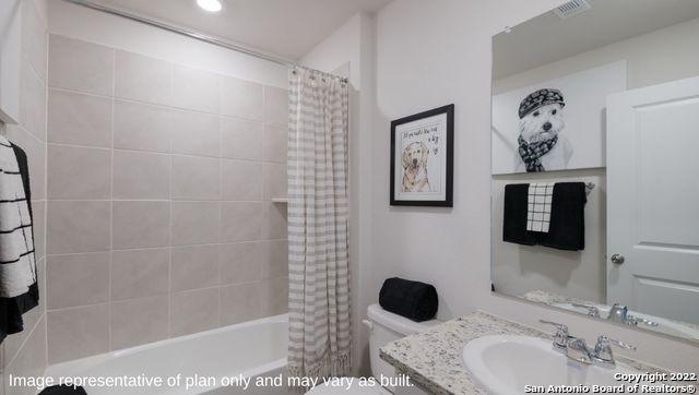 full bathroom with toilet, shower / bath combo, and vanity