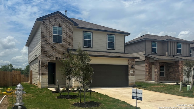 view of front of house featuring a garage and a front lawn