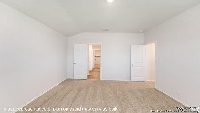 unfurnished bedroom with baseboards, vaulted ceiling, and carpet flooring