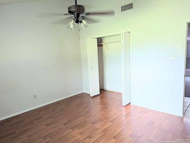 unfurnished bedroom featuring ceiling fan, wood-type flooring, and a closet