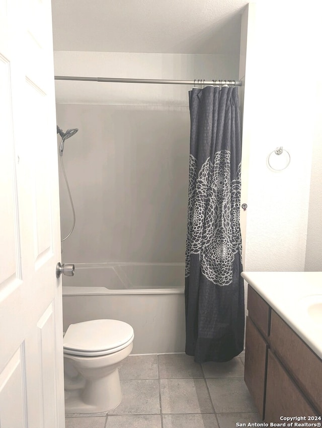 full bathroom with tile patterned floors, vanity, toilet, and shower / tub combo with curtain