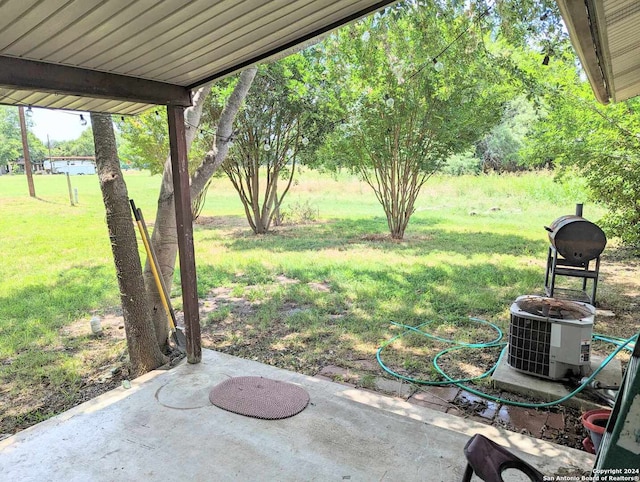 view of yard with a patio area and central air condition unit