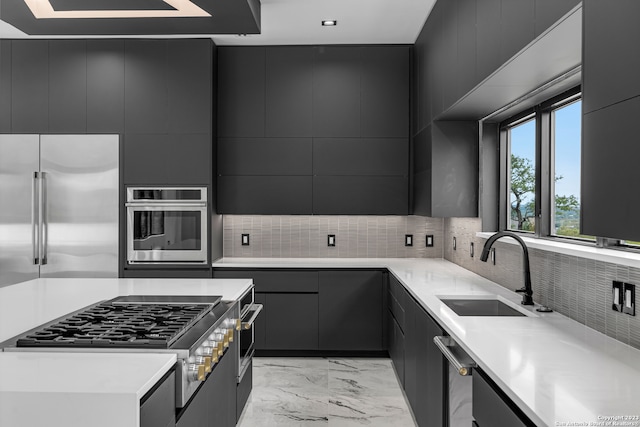 kitchen featuring appliances with stainless steel finishes, backsplash, and sink