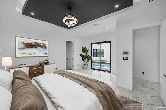 bedroom featuring a raised ceiling and access to exterior