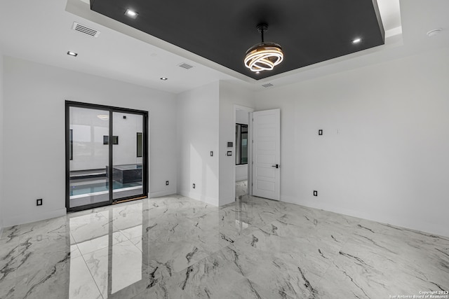 spare room featuring a tray ceiling