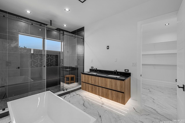 bathroom featuring vanity and independent shower and bath