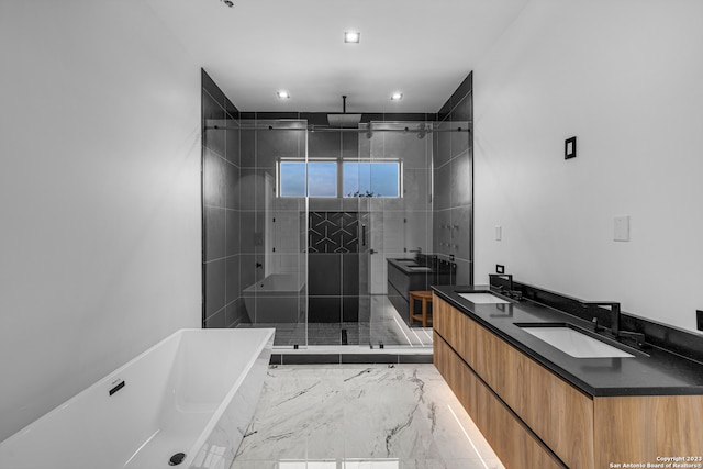 bathroom featuring vanity and independent shower and bath