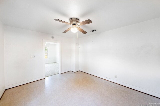 tiled spare room featuring ceiling fan