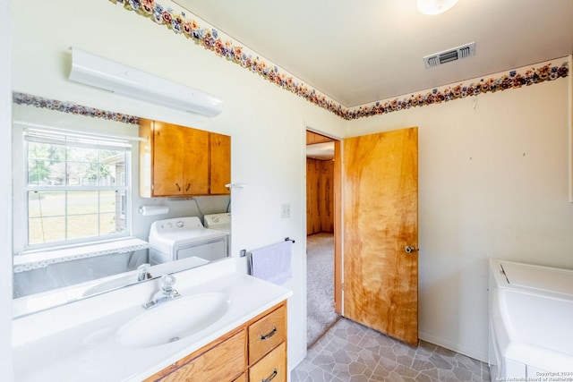 bathroom with tile flooring, separate washer and dryer, and oversized vanity