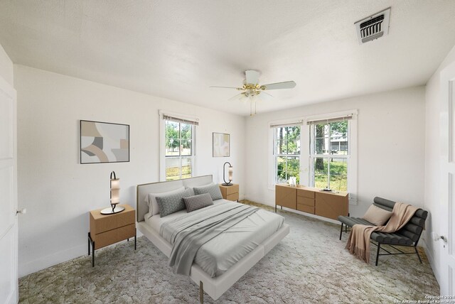 bedroom with carpet, multiple windows, and ceiling fan