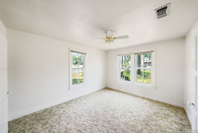 unfurnished room with ceiling fan and carpet floors