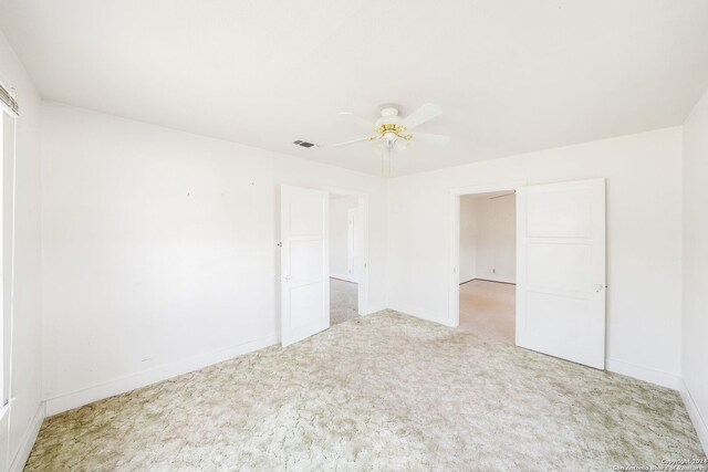 unfurnished room featuring carpet flooring and ceiling fan