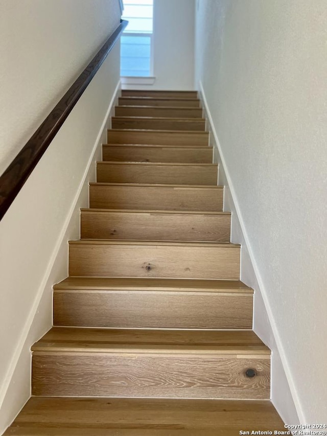 stairs with hardwood / wood-style floors