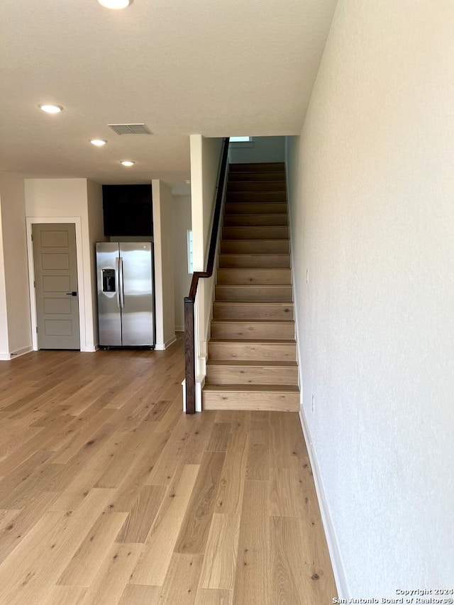 stairway featuring hardwood / wood-style flooring