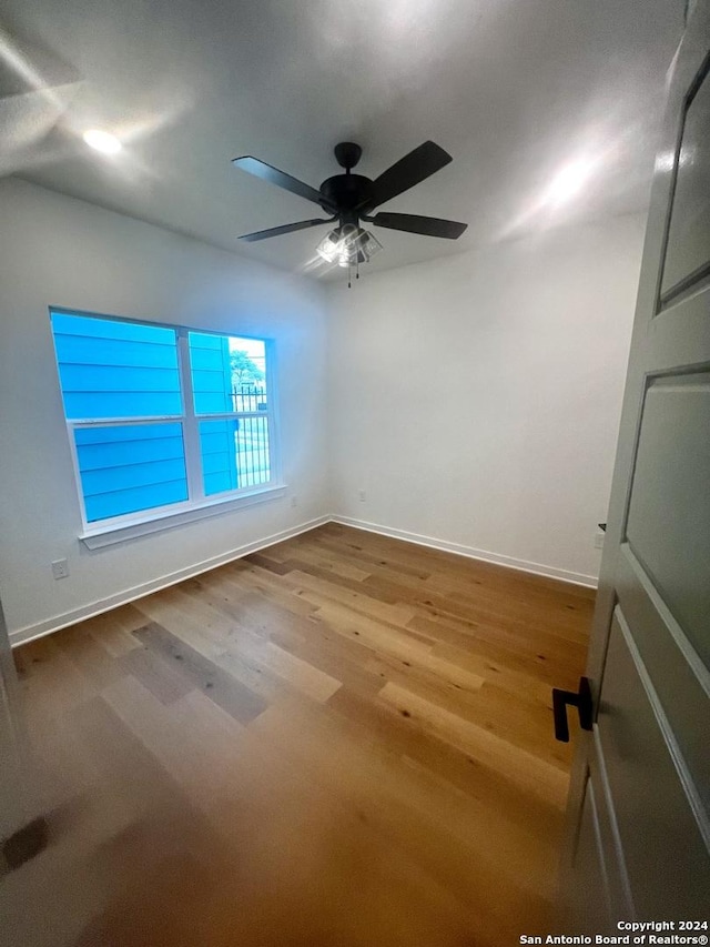 empty room featuring hardwood / wood-style flooring and ceiling fan