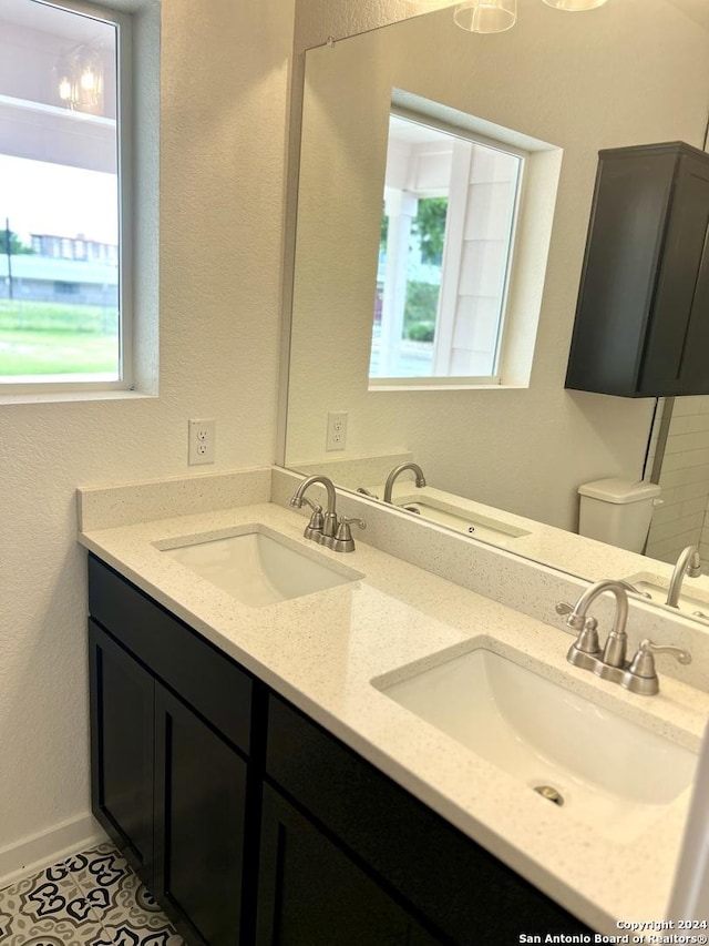 bathroom with tile patterned floors, vanity, and toilet