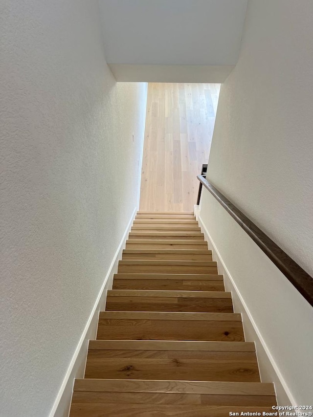 stairway featuring hardwood / wood-style flooring