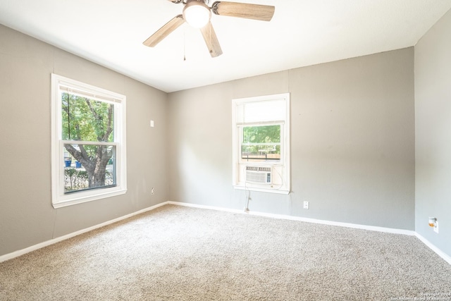 empty room featuring a healthy amount of sunlight, baseboards, carpet floors, and ceiling fan