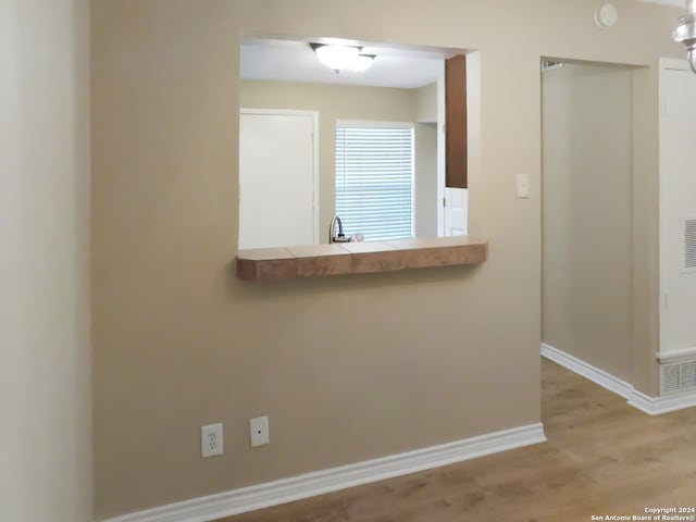 interior space with light hardwood / wood-style flooring and sink