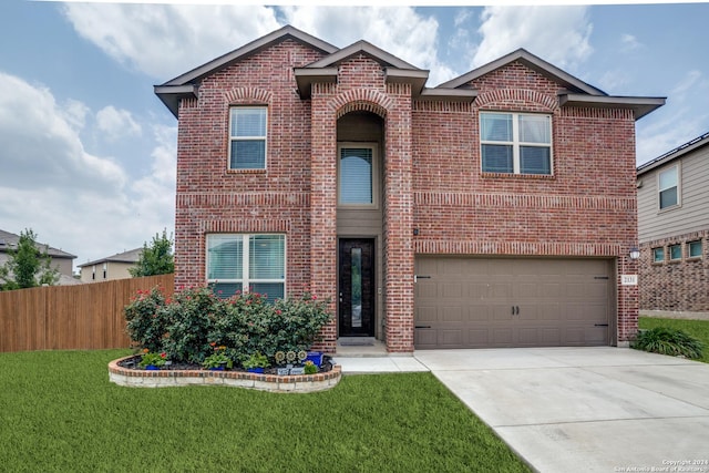 view of property featuring a garage and a front lawn