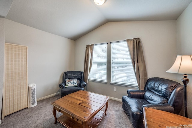 sitting room featuring carpet flooring and vaulted ceiling