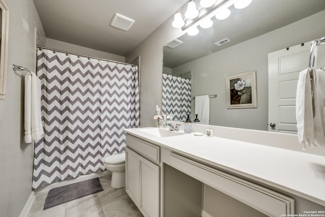 bathroom with curtained shower, tile patterned flooring, vanity, and toilet