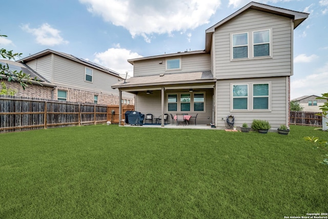 back of house featuring a yard and a patio