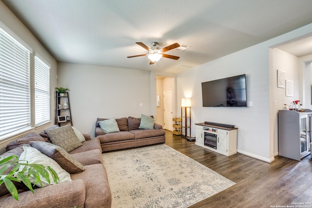 living room with ceiling fan and dark hardwood / wood-style flooring