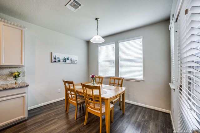 dining space with dark hardwood / wood-style flooring