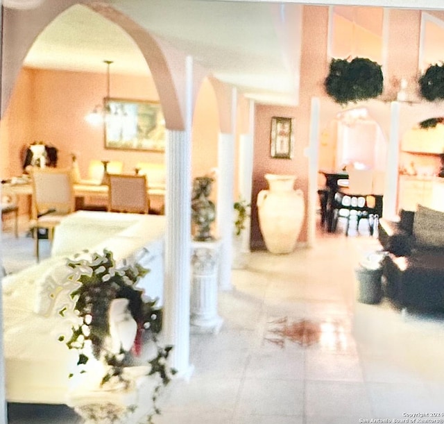 interior space featuring tile patterned flooring and an inviting chandelier