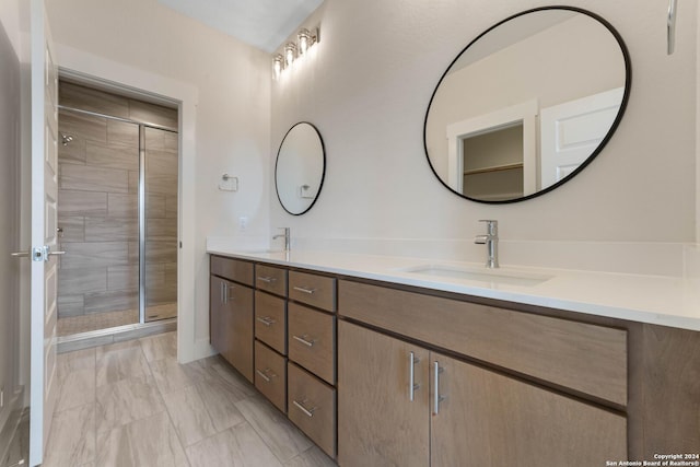 bathroom featuring vanity and an enclosed shower