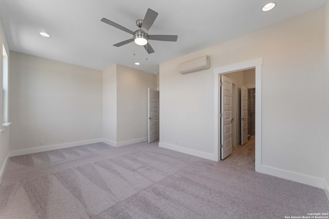 unfurnished bedroom featuring an AC wall unit, ceiling fan, and light colored carpet